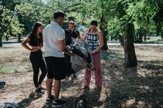 A group of friends works together to assemble a camping tent in a bright park, sharing smiles as they prepare gear for a relaxed outdoor adventure. - Powered by Adobe