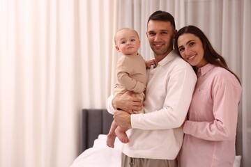 Happy parents with their cute baby at home. Space for text