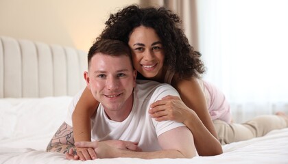 Lovely couple enjoying each other in bed at home