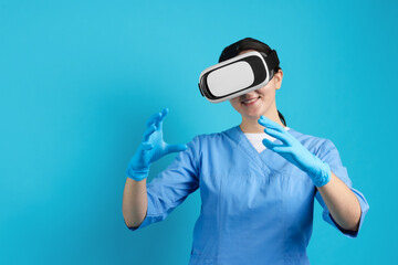 Modern technology. Doctor using virtual reality headset on light blue background. Space for text