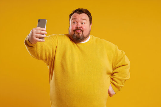 Funny portrait of a plump man taking a selfie