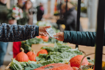 Transaction at a farmers market for fresh produce