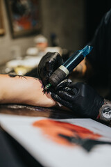 A tattoo artist wearing black gloves uses a tattoo machine to apply a design on a forearm. The scene captures focus, a sterile setup, and the creative energy of body art.