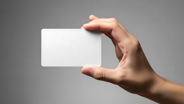 Human hand holding empty white plastic card for your design