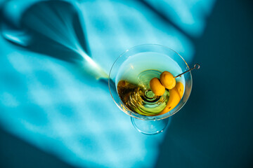 Martini with olives casting an elegant shadow
