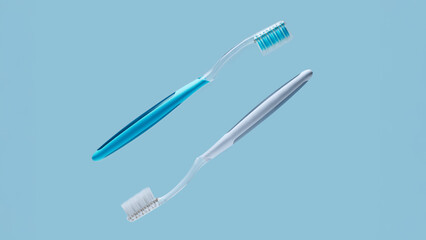 Two plastic toothbrushes on blue background with empty copy space for dental clinic services, oral hygiene education and family healthcare banner design
