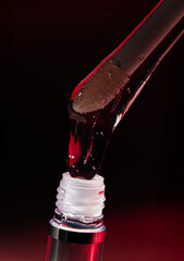 Lip oil applicator with clear glossy formula and bubbles on red background, collection of macro shots for cosmetic branding, skincare hydration and beauty product advertising banners
