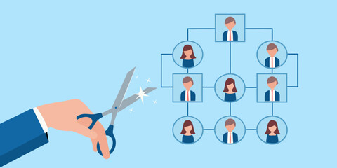 Hand cutting organizational chart with scissors symbolizing restructuring
