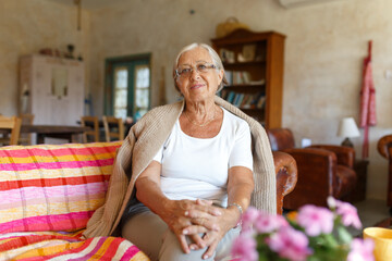 Senior woman relaxing on a sofa at home