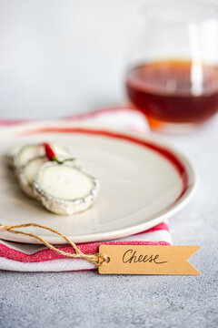 Brie cheese slices with amber wine on plate