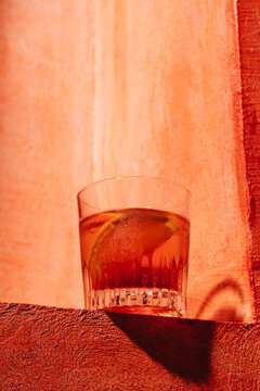 Negroni cocktail on rustic orange background