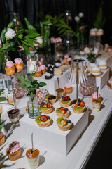 Elegant dessert buffet with fruit tarts and cupcakes