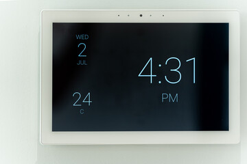 Modern digital clock display on a wall in a London home