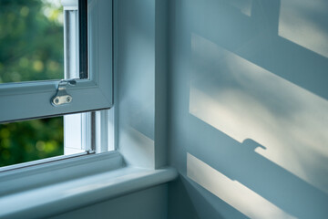 Sunlit shadows on a wall in a London home interior