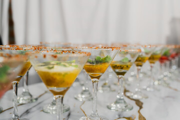 Row of elegant martini cocktails on a white table