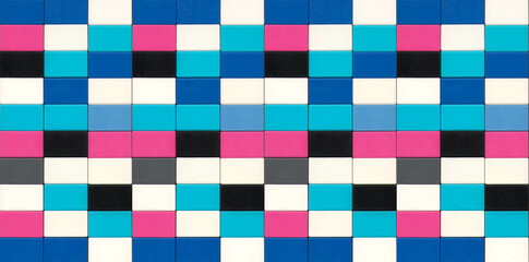 Colorful plastic toy blocks arranged in a tight rectangular pattern, forming a bright geometric background.
