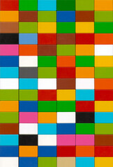 Colorful plastic toy blocks arranged in a tight rectangular pattern, forming a bright geometric background.
