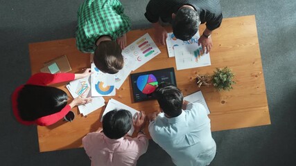 Top down aerial view of business team prepare for meeting and brainstorm marketing idea while planning strategy and looking at investment report or financial graph from tablet. Creative. Convocation. - Powered by Adobe