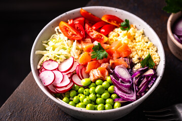 Balanced healthy bowl with vegetables and salmon