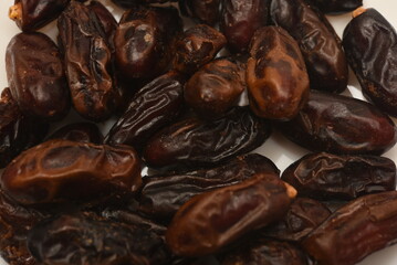 Juicy dates on a plate. Dried fruits. Sweet dried fruits.