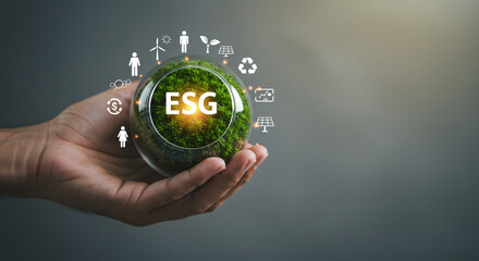 Sustainable business growth concept with ESG principles and green energy icons held in hand
