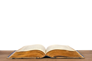 Open vintage large book of XIX century on wooden table close-up on white background