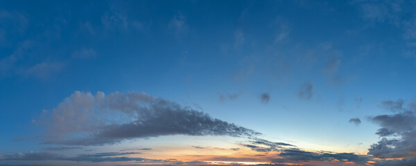 Serene Sunset Sky Over Calm Horizon With Soft Clouds And Blue Light
