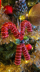 A Christmas tree decorated with various colorful Christmas toys and decor elements.