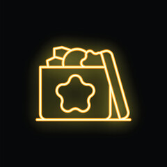Yellow neon sign of an open cardboard box full of toys for child development glowing on a black brick wall