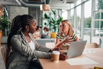 Diverse women collaborating in modern office meeting