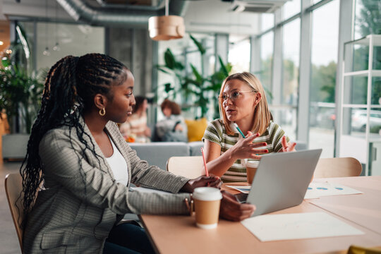 Diverse women collaborating in modern office meeting