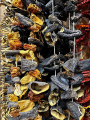 Dark brown eggplant and light-colored squash or tomatoes, such as dried stuffing vegetables, in bunches.