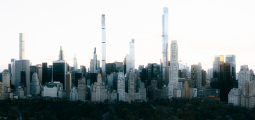 Aerial view of skyscrapers piercing the sky, casting long shadows over the city, a blend of modern architecture and nature, New York, New York, United States.