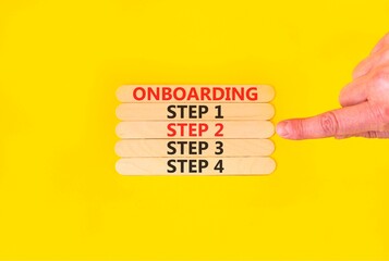 Time to step 2 onboarding symbol. Concept words Onboarding step 2 on beautiful wooden block. Businessman's hand. Beautiful yellow background. Business success step 2 onboarding concept. Copy space.