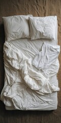 Unmade bed with white sheets and towels on brown carpet