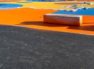 Freshly Painted Rubber Sports Playground Surface with Packaging Film and New Bench