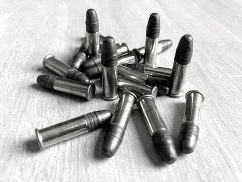 Pack of .22LR caliber bullets on wooden floor