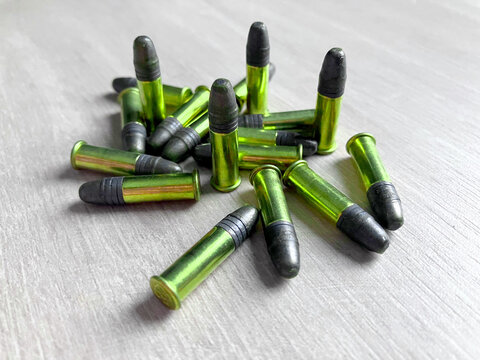 Pack of .22LR caliber bullets on wooden floor