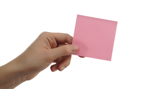 A hand holding a pink square sticky note against a black background in a studio setting shot close up
