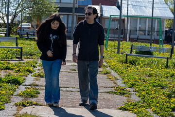 Generational Bonding: Dad and Teen Girl Strolling on Stone Path
