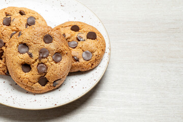 Chocolate chip cookies freshly baked on a ceramic plate