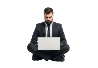 Focused businessman wearing a formal suit and tie sitting cross legged with a laptop isolated on transparent background