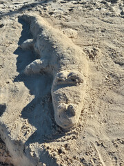 crocodile built with sand on the beach