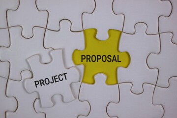 Fototapeta premium Yellow central puzzle piece labeled 'Proposal' connects with a white 'Project' piece, symbolizing how ideas become plans and partnerships through collaboration in business, startups, and teamwork.