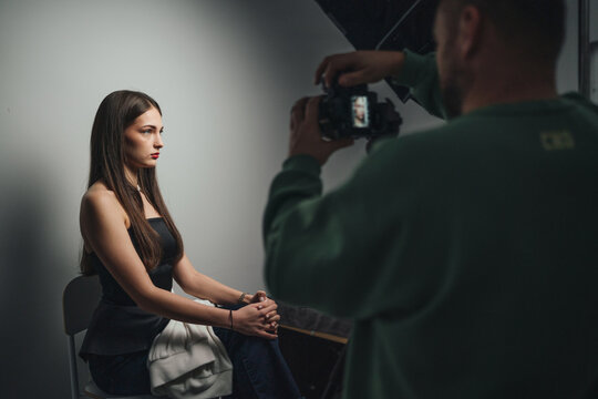 intimate photography session emphasizing thoughtful woman with understated makeup under gentle lighting