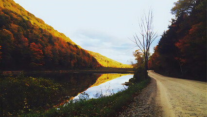 Serene autumn landscape with a winding road reflecting vibrant fall foliage in a calm lake under a cloudy sky