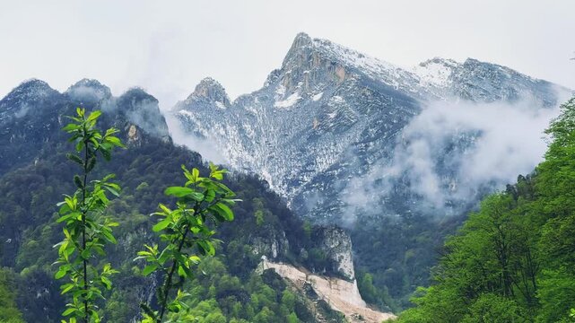 The Green Valley of the Karmadon Gorge with a view of the Kolka Glacier. The Main Caucasian Range. A summer view of the Karmadon Gorge. A mountain valley after a rock and ice collapse. Snowy peaks.4K	