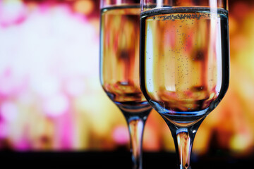 Two glasses of champagne against a backdrop of fireworks