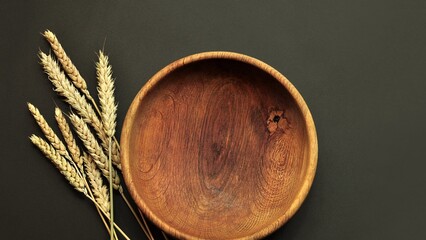 Grain shortage concept. Wheat ears and empty wooden bowl. Cereal nutrition, gluten free concept,...