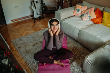 Woman relaxing at home, enjoying music with headphones © Dusan